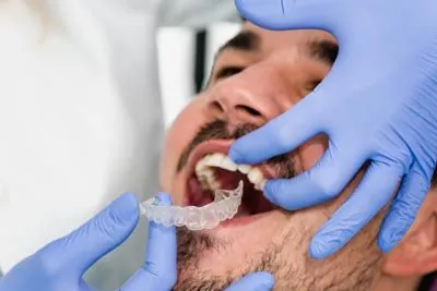 orthodontist placing a patient's clear aligners